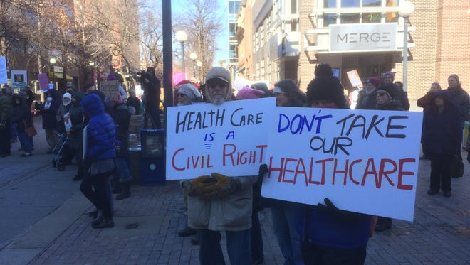 Supporters of the Affordable Care Act gathered on the Iowa City pedestrian mall Saturday for a rally to defend the law.