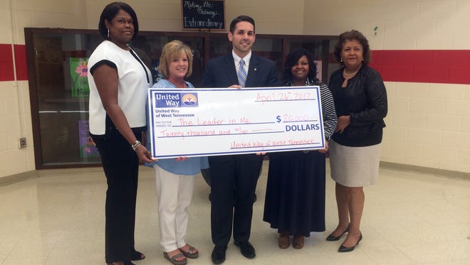 Isaac Lane Principal Janet Gore, Arlington Principal Kippi Jordan, United Way of West Tennessee's Scott Conger, Northway Parkway Middle School Principal Tiffany Taylor and JMCSS Superintendent Verna Ruffin pose with the $20,000 check from United Way.