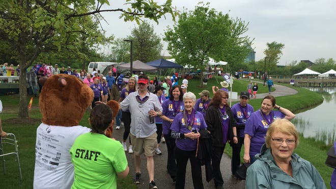 Cancer survivors follow the path through Heritage Park during a Relay for Life event.