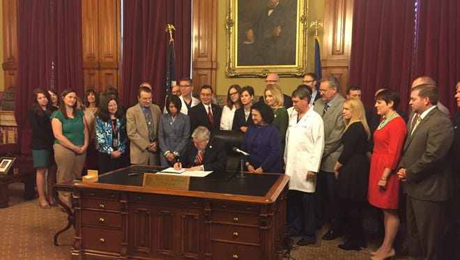 Gov. Terry Branstad signs into law a bill Friday, May 5, 2017, limiting medical malpractice lawsuits.