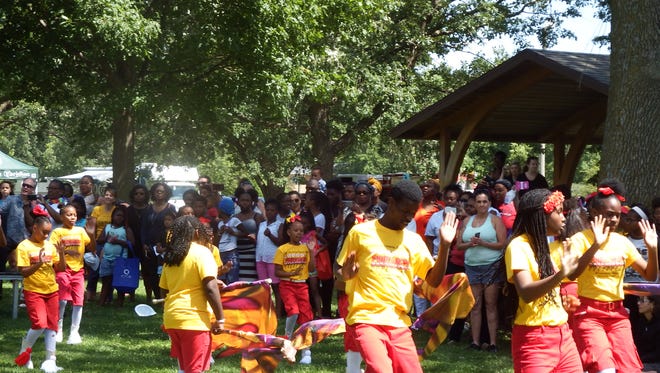 The Union Missionary Baptists Church Crusaders drumeline and drill team performs as part of Iowa City's Juneteenth celebration at Mercer Park on June 24, 2017.