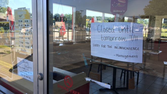 A sign on the door of Mikey's Burgers in Howell on Tuesday, Aug. 1, 2017, tells customers the restaurant is closed and was planned to reopen July 11, the day after an employee filed a complaint with Howell police claiming restaurant owner Michael Bouffard choked him outside the restaurant.