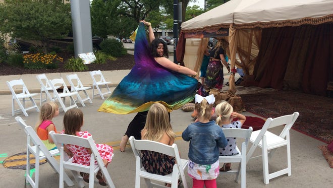 A dancer entertains children at last year's Artstreet.