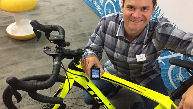 Jake Sigal, CEO of Tome software, shows off a piece of cycling equipment that could be made smarter through a research project his company and Trek Bicycle are launching at Mcity in Ann Arbor. Sigal says smarter bikes and accessories could communicate with cars and trucks and help make cycling safer.