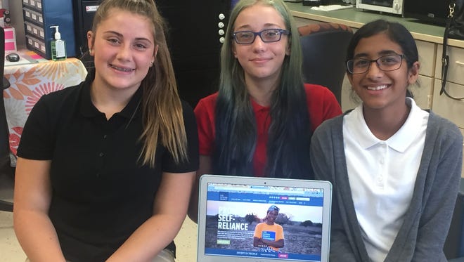 Veterans Memorial Intermediate School students Hannah Tamagni (left to right), Lia Whitesell, and Ruth Elahi designed a video game that captured a first place award in the National STEM Video Game Challenge.