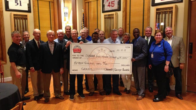 Character and Courage team members present a $15,000 check to Cincinnati Recreation Commission's Miracle League.