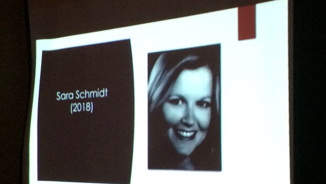 A slideshow shows an image of Sara Schmidt at Friday's vigil. Schmidt died at the hands of her husband, Robert, in January.