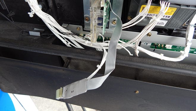 A credit card skimmer is installed in a gas pump.