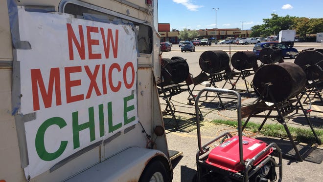 This Aug. 11, 2016, file photo shows Green chile from Hatch, N. M., on sale, at a roadside roasting stand in Santa Fe, N.M. New Mexico farmers produced fewer of the state's famed hot peppers in 2017, and data released Tuesday, March 13, 2018 by federal and state agriculture officials show the value of the chile crop has declined.