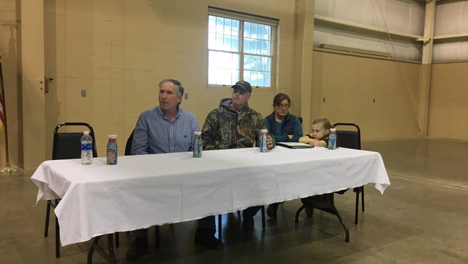 Lebanon County dairy farmers - from left to right, Kirby Horst, Barry Hostetter and Alisha Risser - struggle to contain their emotions Monday while contemplating the possible loss of their livelihood during a rally at the Lebanon Valley Expo Center.