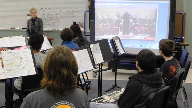 Raa band students silently watch footage of the Stoneman Douglas Wind Symphony at Carnegie Hall.