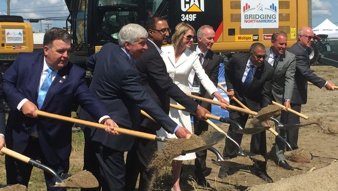 Gov. Rick Snyder (second from left) and Amarjeet Sohi, Canada's Minister of Infrastructure and Communities, (third from left), join other officials in ceremonial groundbreaking for Gordie Howe International Bridge in Detroit's Delray district Tuesday, July 17, 2018.