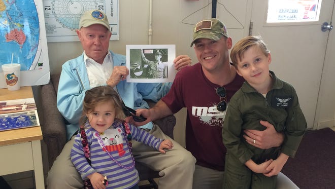 WWII B-17 Bomber pilot Charles Hull (blue jacket) poses with Army National Guard Black Hawk pilot Joe Spears and his children Parker, 2, and Noah, 6, at J.B. Williams Airport on Saturday.