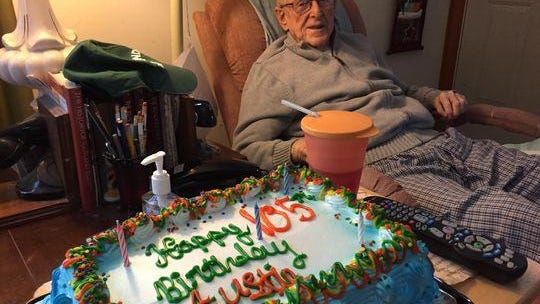 The cake for William “Austin” Clark’s 105th birthday had five candles.