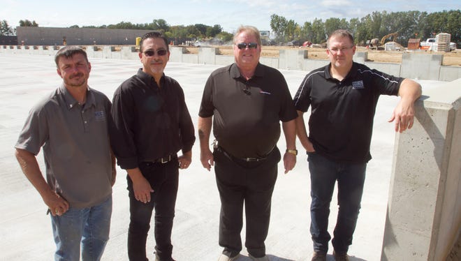 Standing in front of the construction site for CZ Cartage Inc. Wednesday, Sept. 13, 2017, are, from left, Brivar Construction site supervisor Bryan Rosbury, CZ Cartage general manager Eric Boudreau, CZ Cartage co-owner Paul Cornell and Brivar Construction president Craig Stockard. The new site is on East Van Riper Drive in Handy Township.