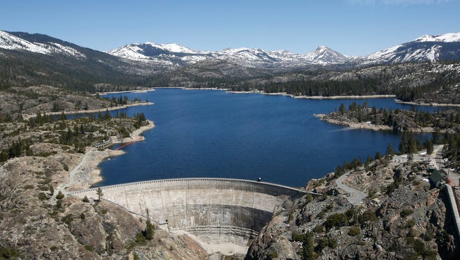 Snow covering the Sierra Nevadas is seen April 3, 2017, in the background of the PG&E hydroelectric dam at Spaulding Lake in Nevada County, Calif. The utility held its monthly winter season snow survey to help determine how much water from snowmelt will be available to provide hydroelectric energy, and the survey showed snowpack to be 160% of normal for this location at this time of the year.