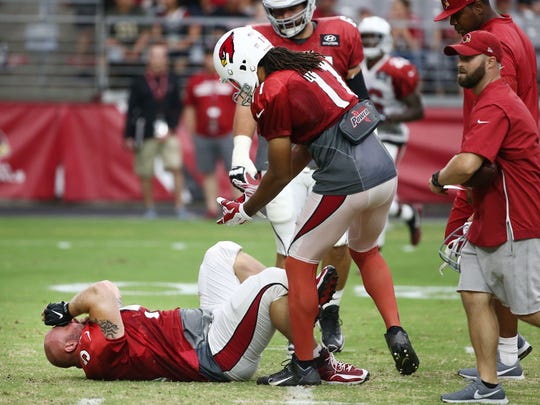 Cardinals center A.Q. Shipley suffers an injury during the Red and White Practice on Saturday.