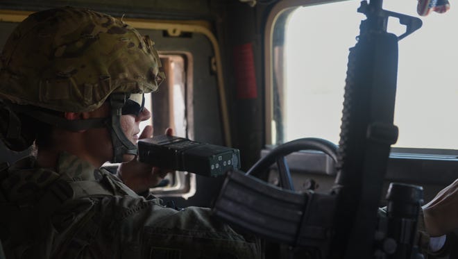 Master Sgt. Shannon Hawkins, a 370th Air Expeditionary Advisory Group, Detachment 1, airfield manager deployed in support of Combined Joint Task Force – Operation Inherent Resolve, communicates with air traffic controllers over the radio in a Humvee at Qayyarah West Airfield, Iraq, July 2, 2017. To ensure seamless control of both Iraqi and coalition air traffic, the Air Force’s 370th AEAG supports the CJTF-OIR advise and assist mission by having a small team of air advisors working alongside the Iraqis advising and assisting in day-to-day airfield operations. CJTF-OIR is the global Coalition to defeat ISIS in Iraq and Syria.