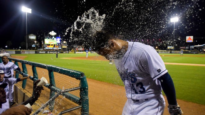 Hooks catcher Carlos Canelon is doused with water after his eighth-inning home run at Whataburger Field on Thursday, August 10, 2017.