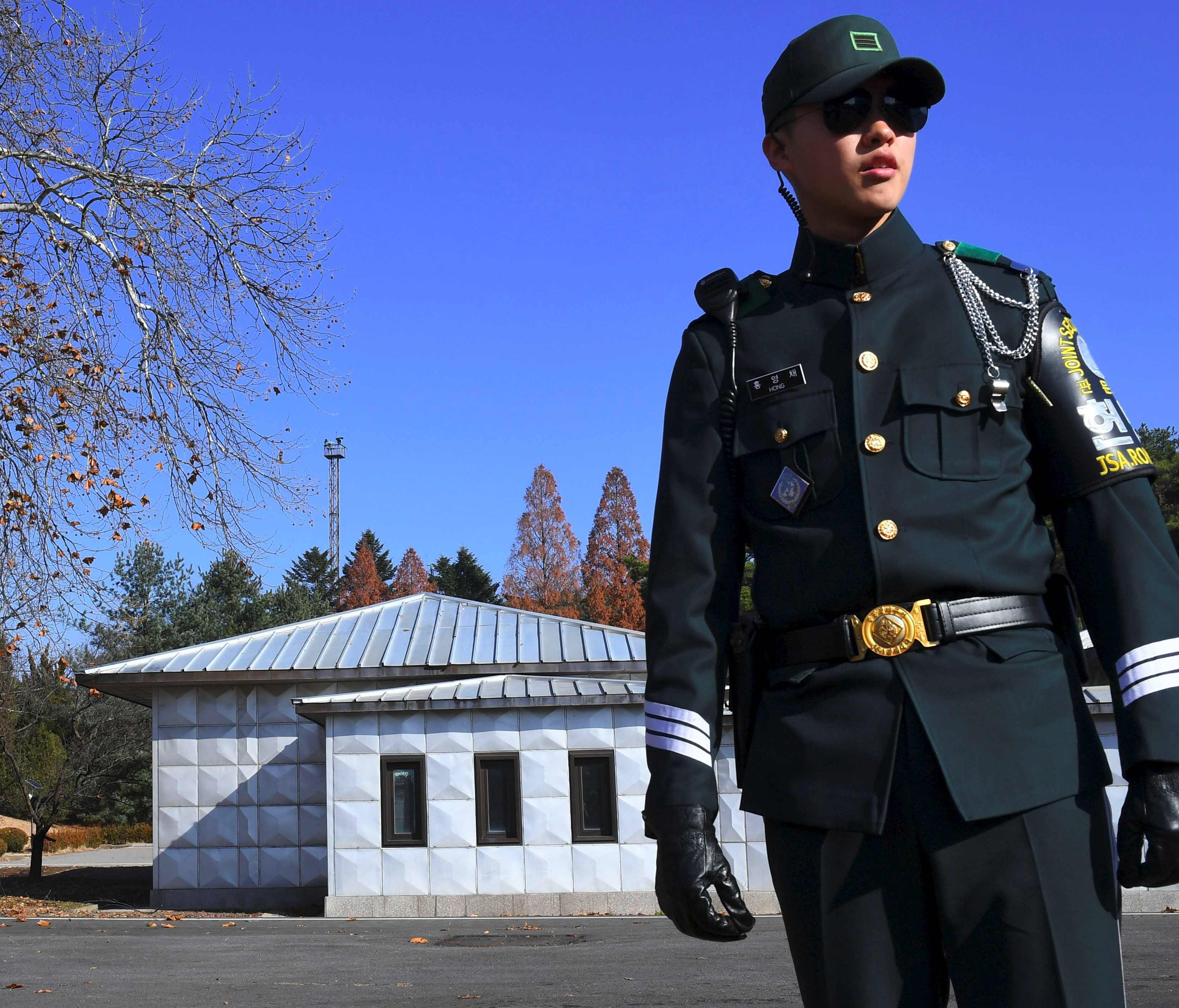 A South Korean soldier stands guard near the spot where a North Korean soldier recently crossed the border line two weeks ago, at the truce village of Panmunjom in the Demilitarized Zone on Nov. 27, 2017.