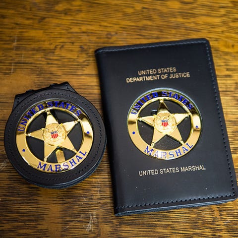 A U.S. Marshals badge.