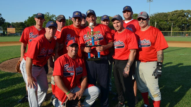 Bridgeton Fire and Rescue team hold up the celebrity game winning trophy after defeating the Bridgeton Police Department team at Alden Field on Saturday.