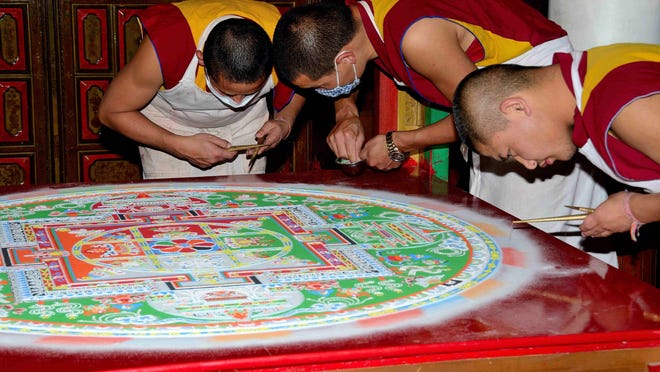 The monks worked tirelessly on this beautiful multicolored and intricately detailed mandala, moving colored sand particles into place with tiny tweezers and pins, one grain at a time.