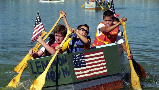 Boy Scouts paddle during a past Star Spangled Sparks celebration.