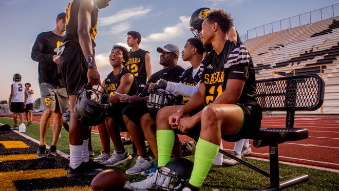 Defensive back coach Bryant Westbrook (center) speaks to his linemen on July 24, 2018, during the Saguaro High School Sabercats' first football practice of the 2018-2019 school year at Saguaro High School in Scottsdale, Arizona.