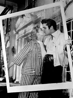 Yvonne Lime, Hollywood starlet, and Elvis Presley looked lovey-dovey at each other on April 19, 1957, in front of Graceland, Elvis' new $100,000 mansion near Whitehaven. Miss Lime, who was visiting for the Easter holidays, had a small part in 'Loving You,' Elvis' second motion picture which premiered July 9 of that year. Production had begun in mid-January and wrapped by mid-March.