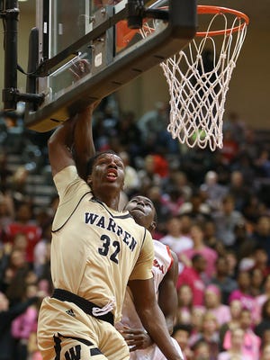 North Central Panthers DJ Johnson (12) fouls Warren Central Warriors Mack Smith (32) during a layup at North Central High School, Indianapolis, Friday, Jan. 27, 2017. Warren Central won, 63-51.