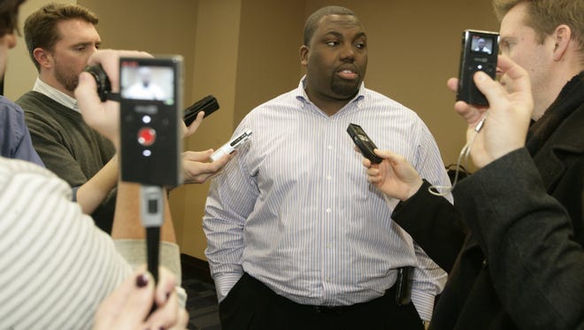 Michigan recruiting coordinator Chris Singletary talks  to reporters after the press conference by head coach Brady Hoke talking about their first Michigan recruiting class in Ann Arbor,  MIch. on Wednesday, February 2  2011.