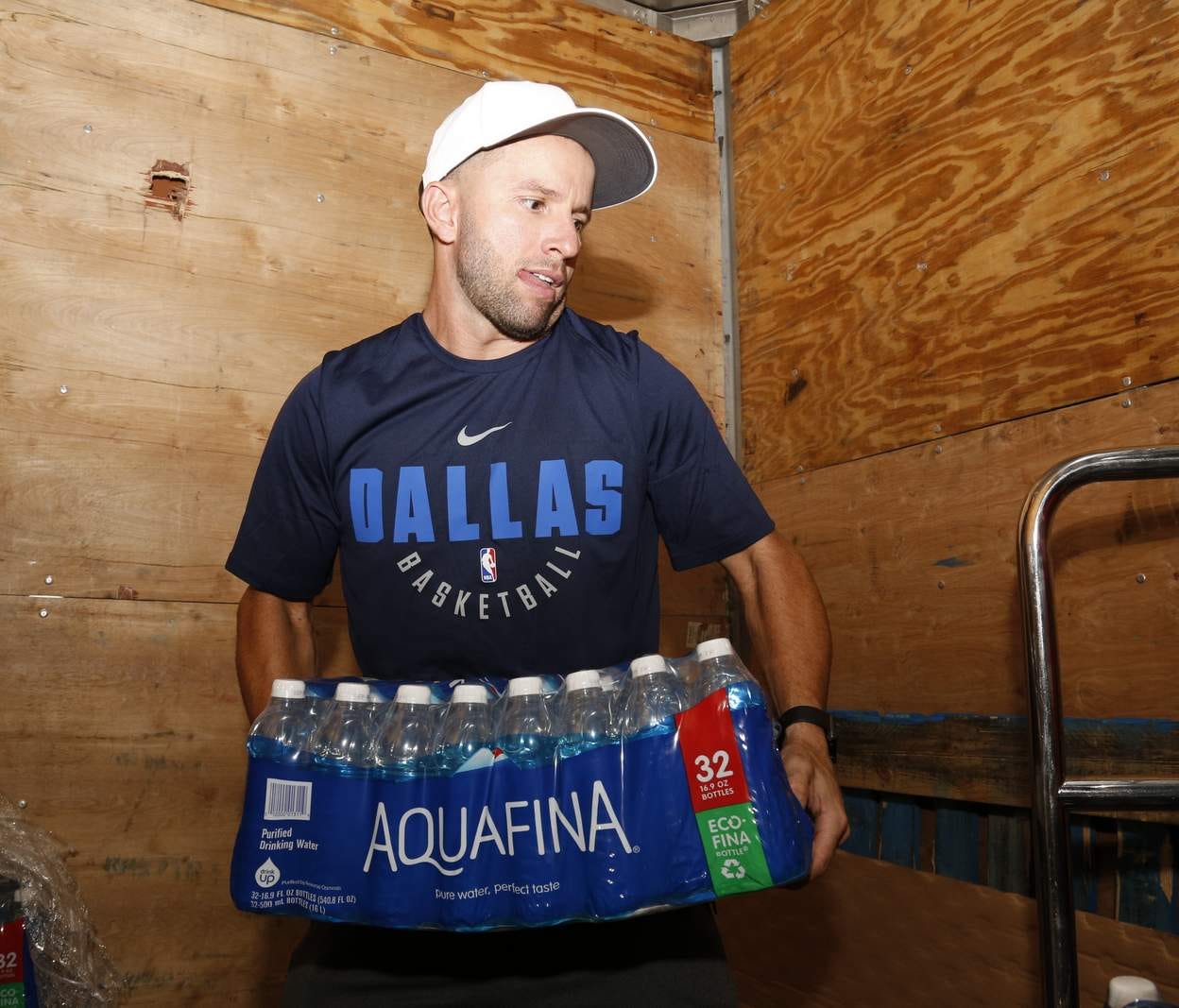 J.J. Barea, of Puerto Rico, loads water and other supplies for victims of Hurricane Maria.