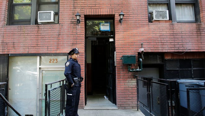 A New York Police Department officer stands guard at the door of an apartment building in the Chelsea neighborhood of New York on Monday. Police are investigating the death of a 38-year-old Long Island dermatologist found unconscious in the building's vestibule. Police say Kiersten Cerveny, of Manhasset, N.Y., was found at about 8:30 a.m., Sunday, inside the five-story walk-up building on West 16th Street.
