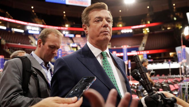 In this July 17, 2016, file photo, Paul Manafort talks to reporters on the floor of the Republican National Convention at Quicken Loans Arena in Cleveland.