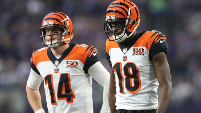 Cincinnati Bengals quarterback Andy Dalton (14), left, and Cincinnati Bengals wide receiver A.J. Green (18) reacts to an incomplete pass play in the third quarter during the Week 15 NFL game between the Cincinnati Bengals and the Minnesota Vikings, Sunday, Dec. 17, 2017, at U.S. Bank Stadium in Minneapolis, Minnesota.