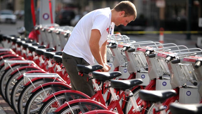 Peter Moorhouse, a part-time Red Bike worker, gets the bikes ready for the grand opening at The Banks.
