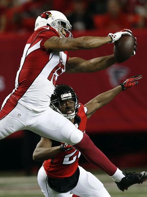 Atlanta Falcons free safety Dwight Lowery (20) defends as Arizona Cardinals wide receiver Michael Floyd (15) makes the catch during the first half Sunday.