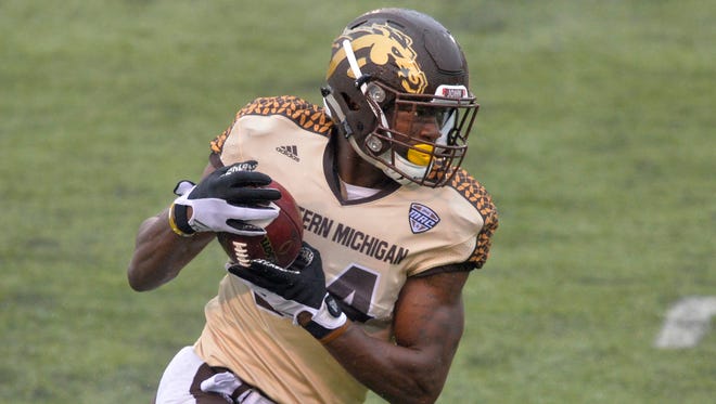 In this Nov. 27, 2015, file photo, Western Michigan wide receiver Corey Davis runs with the ball for a 30-yard touchdown reception against Toledo in an NCAA college football game in Toledo, Ohio.