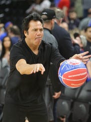 Pistons owner Tom Gores passes a ball after the Pistons'