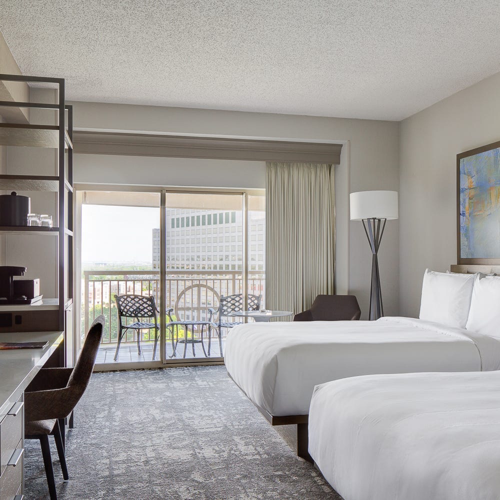 This newly renovated guest room at the Dallas Marriott Las Colinas has a balcony.