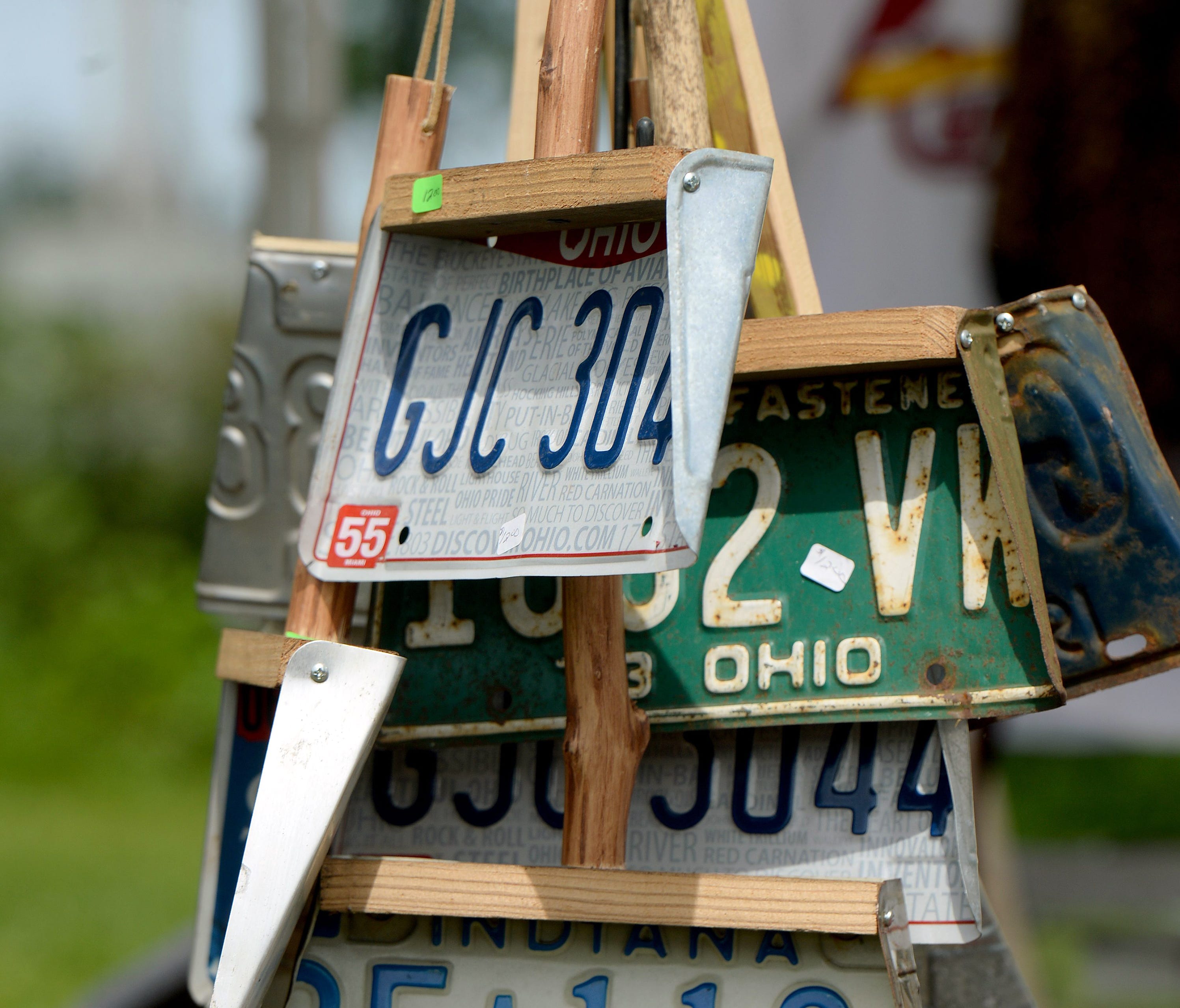 Expired license plates are recycled into dust pans at one Centerville, Ind., vendor's spot June 3, 2016, along the Historic National Road Yard Sale route.