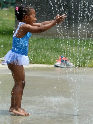 Mariah Chandler plays in water sprays at the splash pad in 2015 at Glen Miller Park in Richmond.