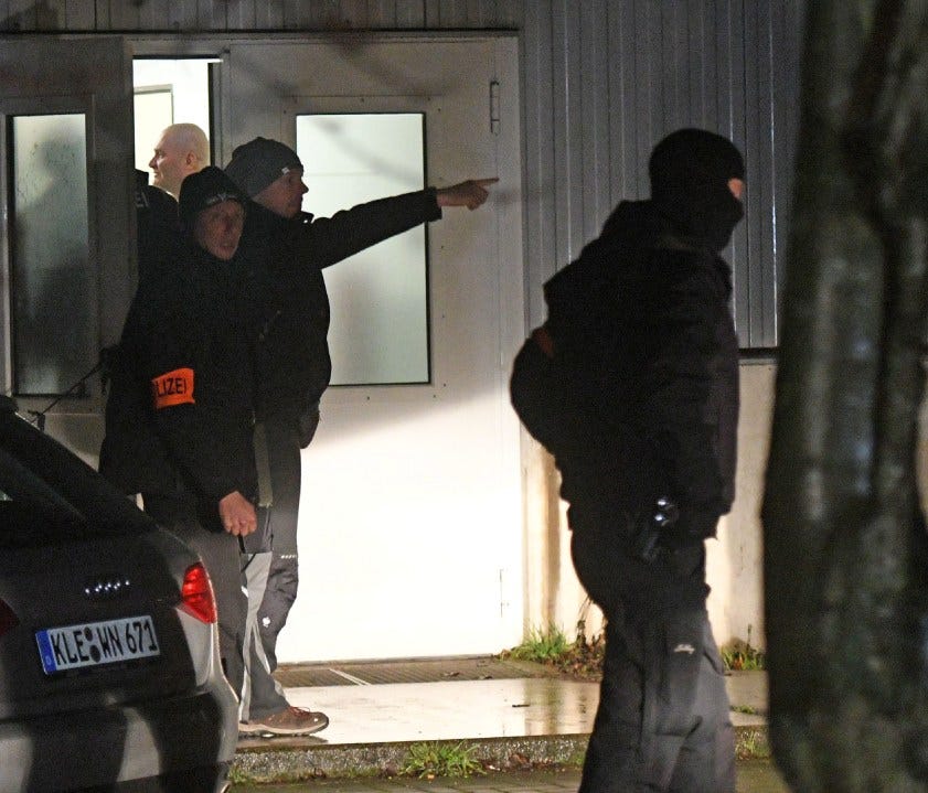 Policemen stand in front of a refugee camp during a search in Emmerich, Germany, on Dec. 22.