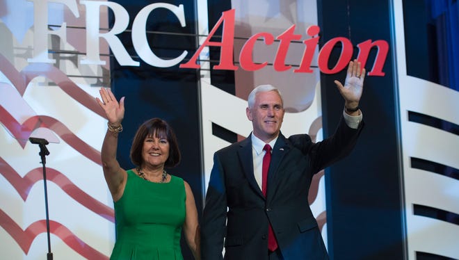 Republican vice presidential candidate Indiana Gov. Mike Pence and his wife Karen take the stage prior to his speaking at the Value Voters Summit in Washington Sept. 10, 2016.