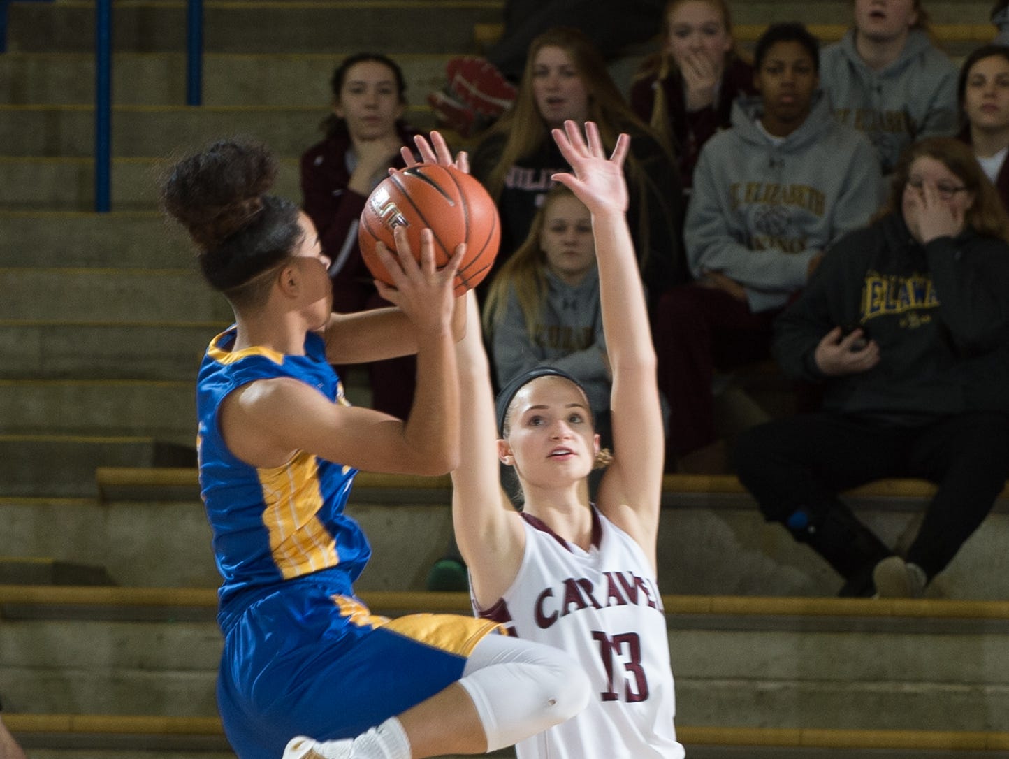 A.I. duPont’s Lauryn Griffin (2) jumps up for a shot over Caravel’s Grace Lange (13) during the first period of their game in the quarterfinals of DIAA Girls Basketball Tournament at the University of Delaware.