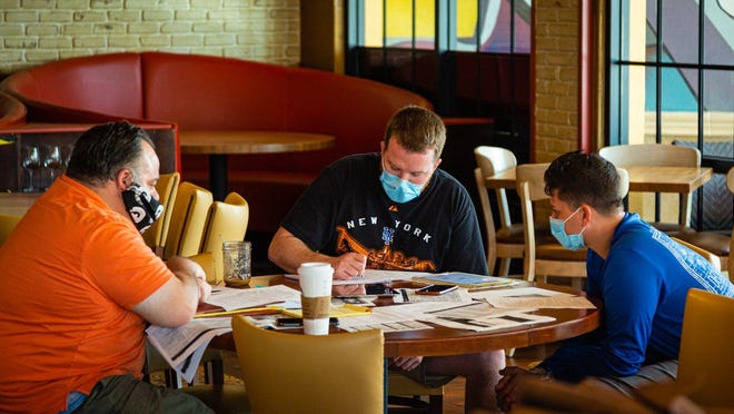 From left to right: Managers Steve Mann, Kevin Burns and Mike Digeronimo strategize the opening of Burt & Max's restaurant in Delray Beach for takeout, Wednesday, April 29, 2020. The restaurant will open for takeout, Monday, May 4.