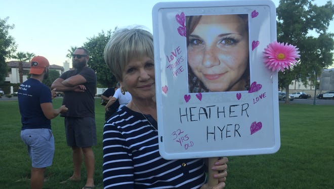 Palm Springs resident Eileen Stern holds a sign with a photo of Heather Heyer, who was killed at a rally in Charlottesville, Virginia Saturday.