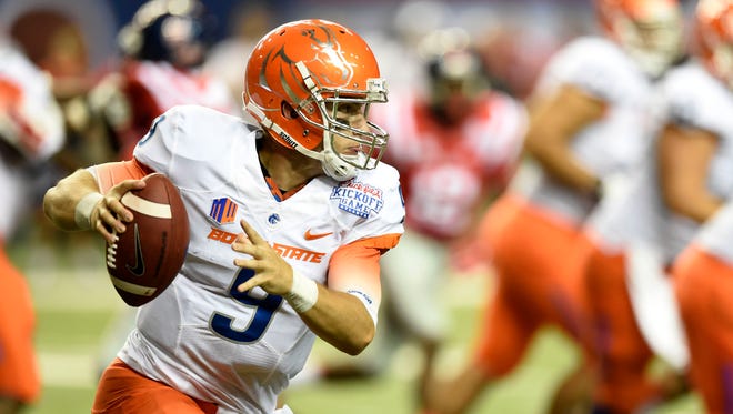 Boise State Broncos quarterback Grant Hedrick (9) runs against the Mississippi Rebels during the third quarter of the 2014 Chick-fil-A kickoff game at the Georgia Dome.