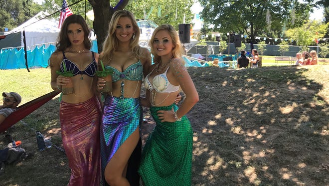 Chelsey Malm (left), Samantha Strong (middle) and Alex Gaines pose as mermaids at the Forecastle Festival.